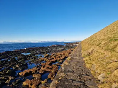 a rocky shoreline with the ocean in the background at Seaview Retreat in Troon