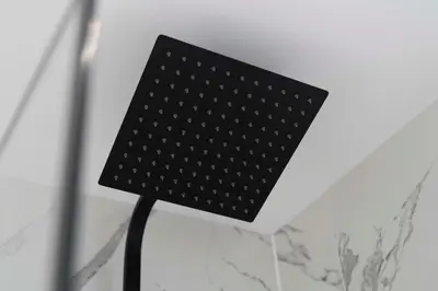 a black lamp sitting on top of a wall at Linden House in Hamilton