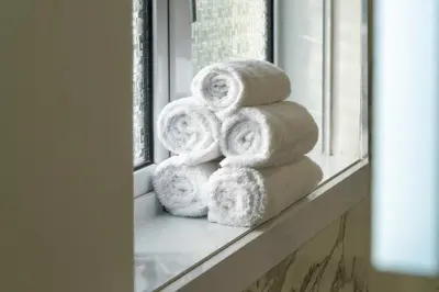 a pile of towels sitting on a window sill at Linden House in Hamilton