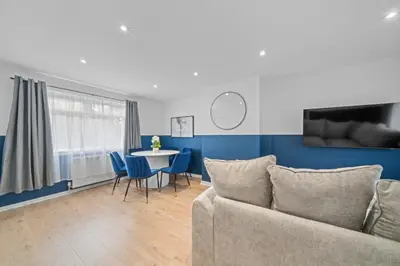 a living room with a couch and a table at Linden House in Hamilton