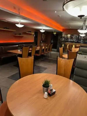 a dining room with a wooden table and chairs at west park hotel PVT ltd in Clydebank