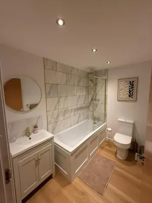 a bathroom with a tub and a toilet and a sink at Modern&Stylish city centre apartment with parking in Glasgow
