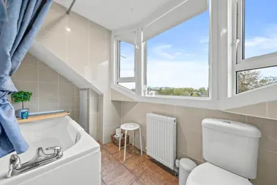a bathroom with a toilet and a window at Charming Village Escape 3-Bed near Loch Lomond in Drymen