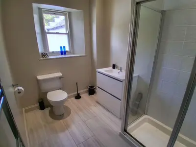 a bathroom with a toilet and a sink and a shower at Hillside House in Dunfermline