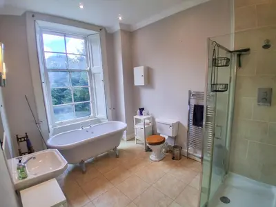 a bathroom with a tub and a sink and a shower at Hillside House in Dunfermline