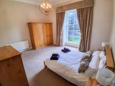 a bedroom with a bed and a window at Hillside House in Dunfermline