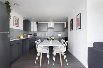 a kitchen with a white table and white chairs at For Students Only Westfield in Edinburgh in Edinburgh