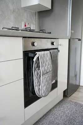 a kitchen with a stove with two towels on the oven at 2 BDR Apartment By Caledonia Luxe Stays Short Lets & Serviced Accommodation Airdrie in Airdrie