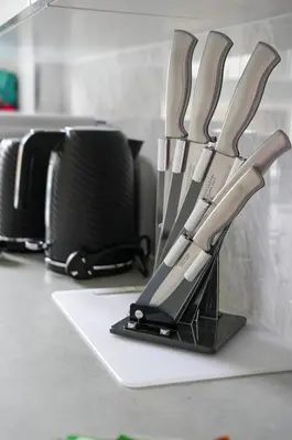 a kitchen counter with a bunch of knives in a holder at 2 BDR Apartment By Caledonia Luxe Stays Short Lets & Serviced Accommodation Airdrie in Airdrie