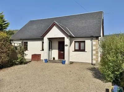 a white house with a black roof at Sealladh Mor-Cottage in Lamlash, Arran in Lamlash