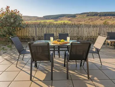 a table and chairs with a plate of fruit on it at Sealladh Mor-Cottage in Lamlash, Arran in Lamlash