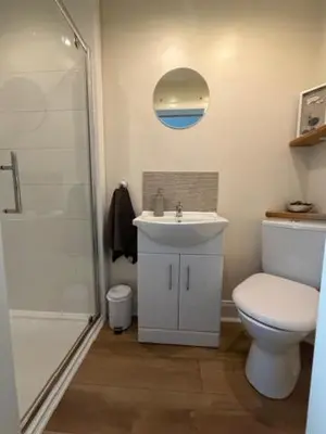 a bathroom with a toilet and a sink and a shower at Four Woodside in Craighouse