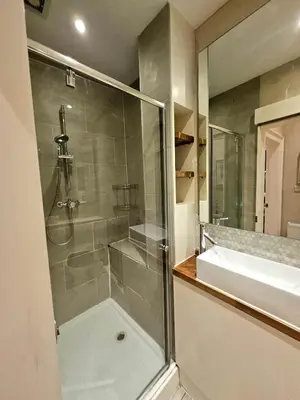 a bathroom with a shower and a sink at 2 Bedroom Apt, 4 Beds, 3 TV near Fountain Park in Edinburgh
