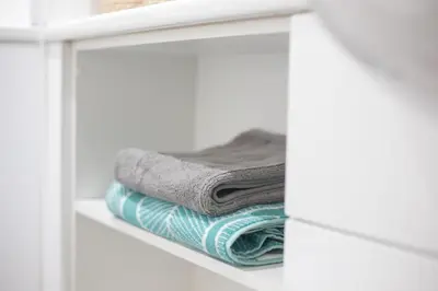 a stack of towels on a shelf in a bathroom at For Students Only - The Ballet School in Glasgow in Glasgow