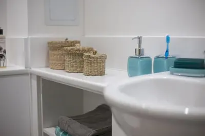 a bathroom with a sink and a toilet and baskets at For Students Only - The Ballet School in Glasgow in Glasgow