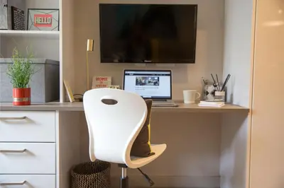 a desk with a computer and a white chair at For Students Only - Willowbank in Glasgow in Glasgow