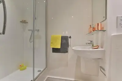 a white bathroom with a sink and a shower at For Students Only - Willowbank in Glasgow in Glasgow