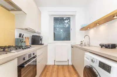 a kitchen with a sink and a stove top oven at Private Hot Tub - Zen & Bubbles in Edinburgh