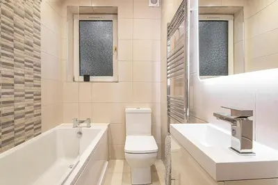 a bathroom with a tub and a toilet and a sink at Private Hot Tub - Zen & Bubbles in Edinburgh
