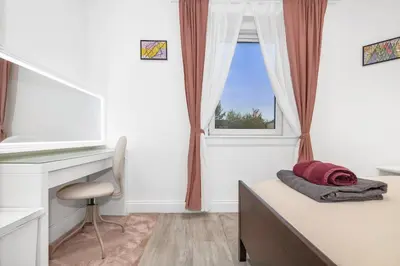 a bedroom with a desk and a bed and a window at Private Hot Tub - Zen & Bubbles in Edinburgh