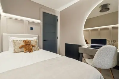 a teddy bear sitting on a bed in a bedroom at 2BR West End Apartment Near Botanic Gardens in Glasgow