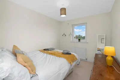 a white bedroom with a bed and a window at Free Parking - Central - 2 Bedroom - 4 Guests in Livingston