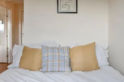 a pile of pillows sitting on a white couch at Free Parking - Central - 2 Bedroom - 4 Guests in Livingston