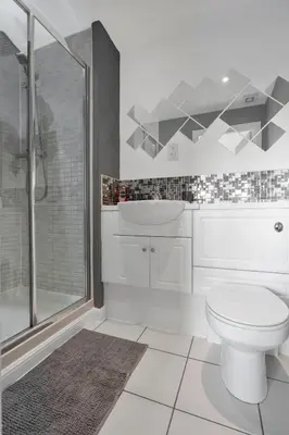 a white bathroom with a toilet and a shower at Free Parking - Central - 2 Bedroom - 4 Guests in Livingston