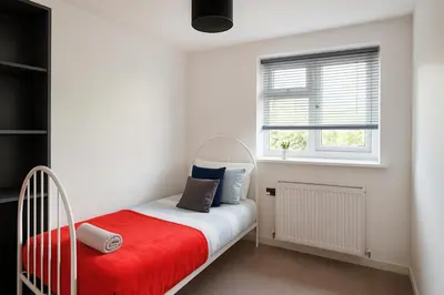 a bedroom with a crib and a window at 3 Bedroom Cozy House-Short and Long Stay in Moffat