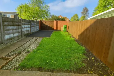 a backyard with a fence and a green lawn at 3 Bedroom Cozy House-Short and Long Stay in Moffat