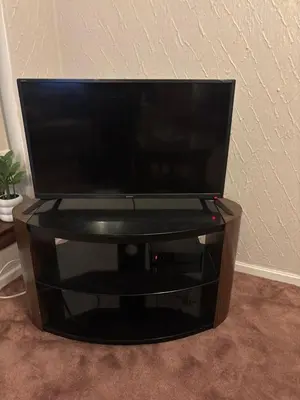 a flat screen tv sitting on top of a tv stand at OakHouse- Entire 3 Bedroom Terrace House with Free Parking in Cumbernauld