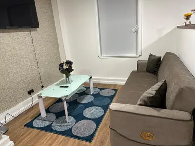 a living room with a couch and a table at Edinburgh Rose Suites 1BHK Central EB4 in Edinburgh