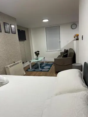 a room with a bed and a couch and a table at Edinburgh Rose Suites 1BHK Central EB4 in Edinburgh