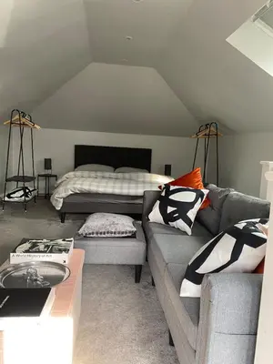 a living room with a couch and a bed at Coorie Cottage in Edinburgh