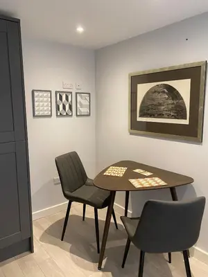 a dining room with a table and two chairs at Coorie Cottage in Edinburgh