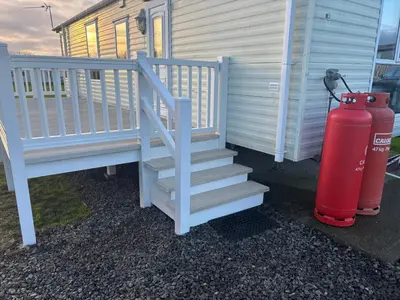 a fire hydrant and stairs next to a house at Montrose No3 - Turnberry Holiday Park in Turnberry