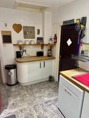 a kitchen with white cabinets and a counter top at Seaview Cottage Bellochantuy