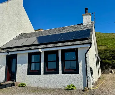 a house with solar panels on the roof at Seaview Cottage Bellochantuy
