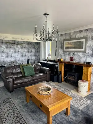 a living room with a couch and a table at Seaview Cottage Bellochantuy