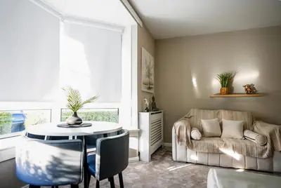 a living room with a table and a couch at Caldwell House in Glasgow