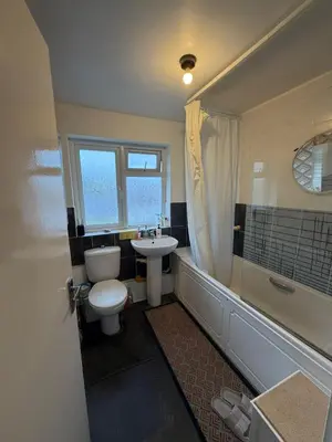 a bathroom with a toilet and a sink and a tub at Private Room in Berkhamsted high street in Moffat
