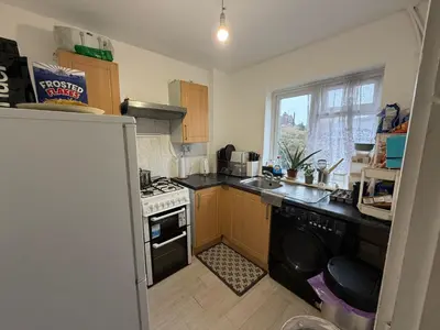 a small kitchen with a stove and a refrigerator at Private Room in Berkhamsted high street in Moffat