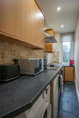 a kitchen with a counter top with a microwave at Neilston Gateaway in Paisley