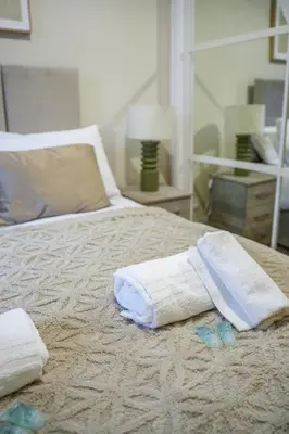 a bed with towels on top of it at Neilston Gateaway in Paisley