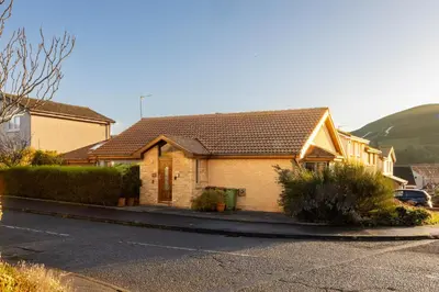 a house on a street next to a parking lot at Bright, spacious house in Edinburgh