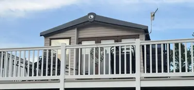 a small house with a white fence at Wemyss Bay Seaview Sanctuary in Wemyss Bay