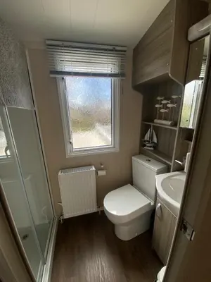 a small bathroom with a toilet and a sink at Wemyss Bay Seaview Sanctuary in Wemyss Bay