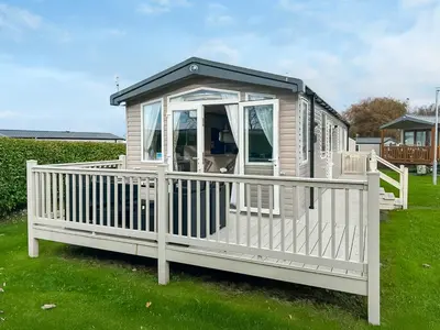 a white house with a porch on the grass at Rorys Retreat - Ukc7144 in Ayr