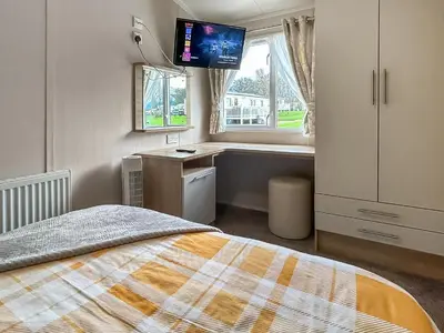 a bedroom with a bed and a desk and a television at Rorys Retreat - Ukc7144 in Ayr