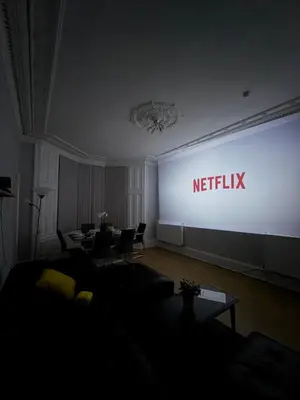 a meeting room with a screen with the netflix sign at FREE Pool Table Cinema Room TableTennis AirHockey Glasgow City in Glasgow